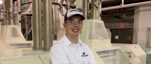 Cody Blodgett in a flour mill, resting against a rollstand